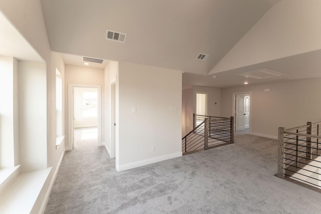 interior space with light carpet and high vaulted ceiling