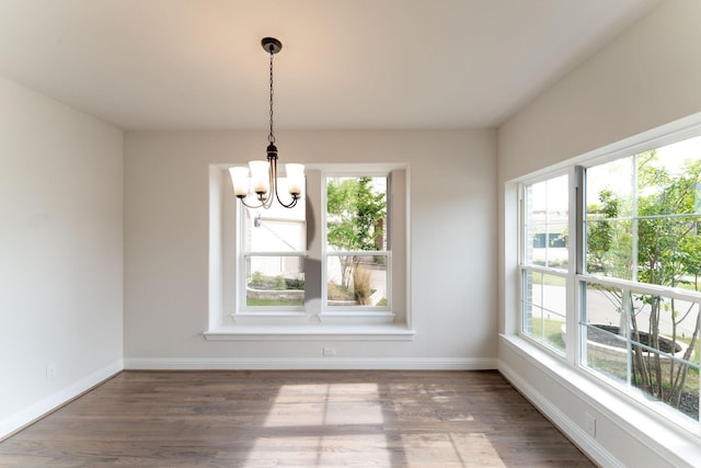 unfurnished dining area featuring dark hardwood / wood-style flooring and a healthy amount of sunlight