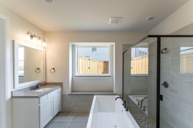 bathroom with independent shower and bath, vanity, and tile patterned flooring