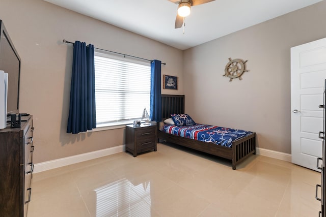 tiled bedroom featuring ceiling fan