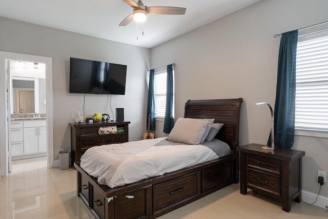 bedroom with ceiling fan and ensuite bath