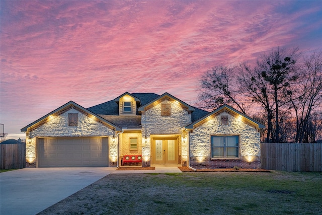 view of front facade featuring a yard, a garage, and french doors