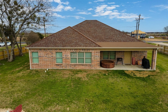 back of property featuring a yard and a patio area