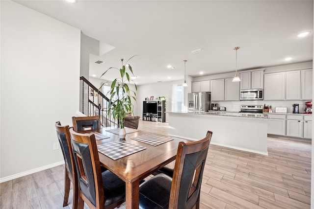 dining room with light hardwood / wood-style flooring