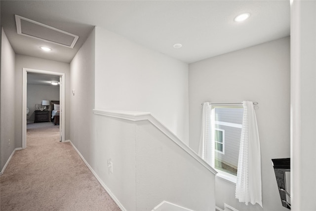 hallway with light colored carpet