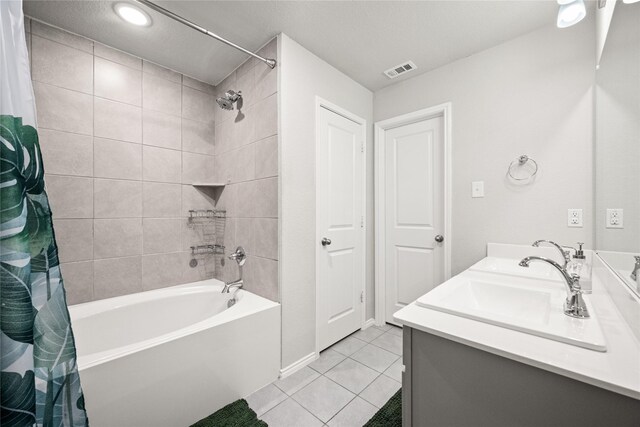 bathroom featuring tile patterned flooring, vanity, a textured ceiling, and shower / bath combo with shower curtain