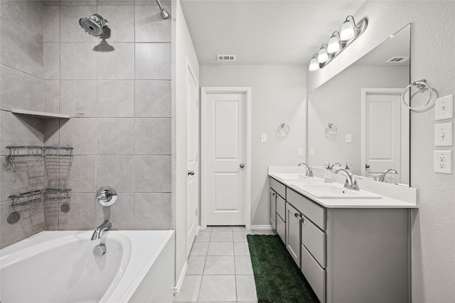 bathroom featuring tiled shower / bath combo, vanity, and tile patterned floors