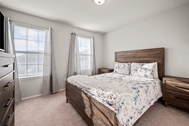 bedroom featuring light carpet