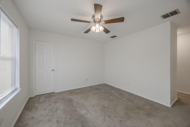 spare room with ceiling fan, lofted ceiling, and carpet