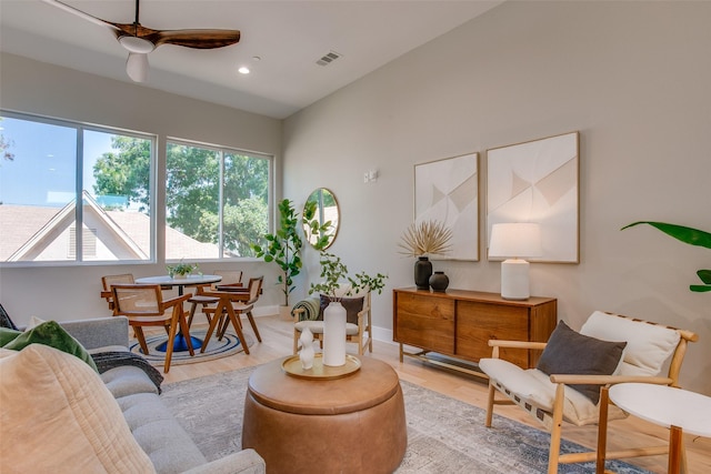 living room featuring ceiling fan and light hardwood / wood-style floors