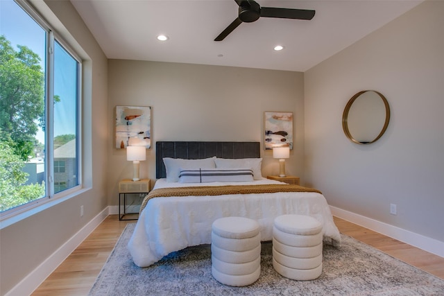 bedroom with ceiling fan and light hardwood / wood-style floors