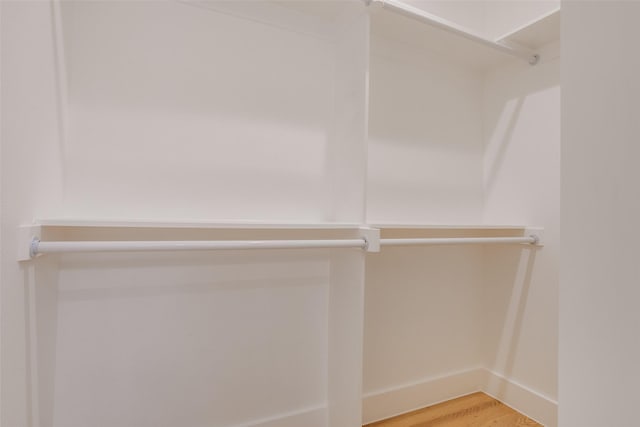 walk in closet with wood-type flooring