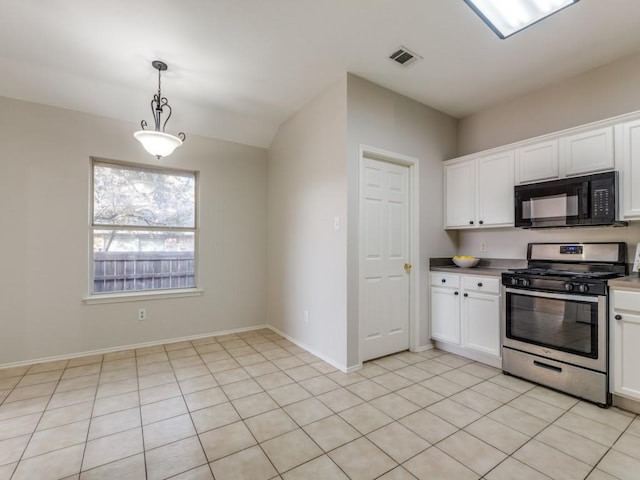 kitchen featuring white cabinetry, decorative light fixtures, stainless steel gas range, and light tile patterned floors