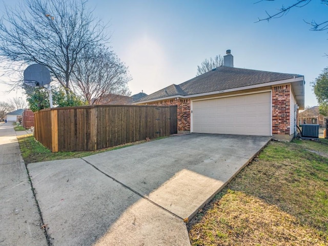 exterior space with a garage and central air condition unit