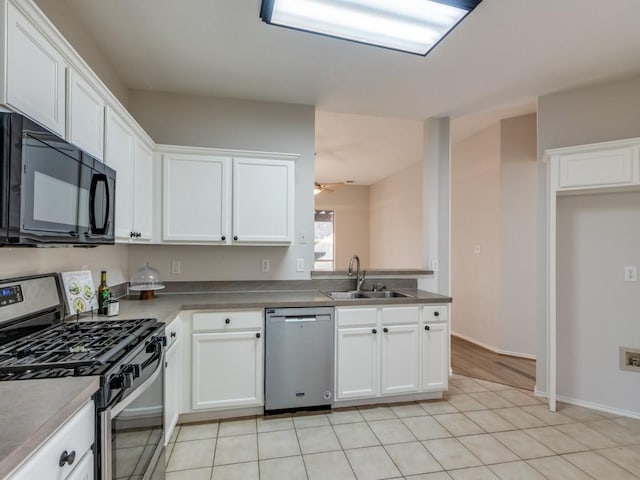 kitchen featuring sink, stainless steel appliances, white cabinets, and ceiling fan