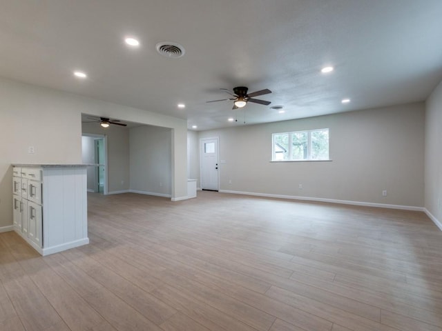 unfurnished living room with light hardwood / wood-style flooring and ceiling fan