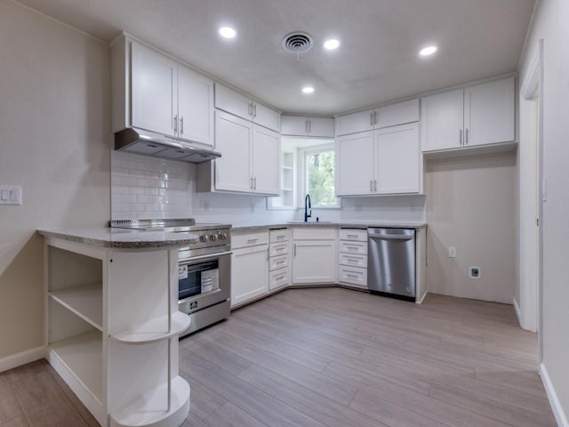 unfurnished living room with sink, ceiling fan, and light wood-type flooring