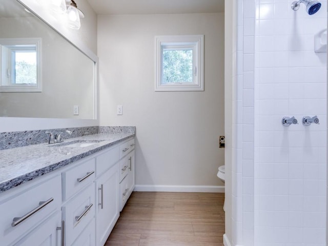 kitchen with tasteful backsplash, white cabinetry, sink, stainless steel appliances, and light hardwood / wood-style flooring