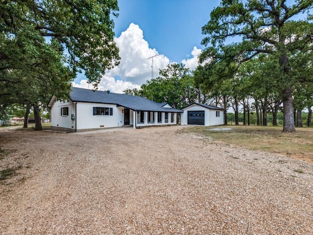 ranch-style home with an outbuilding and a garage