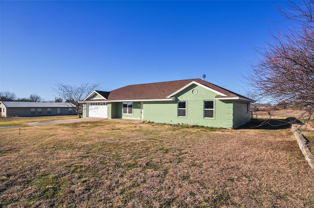 view of front of house featuring a garage and a front lawn