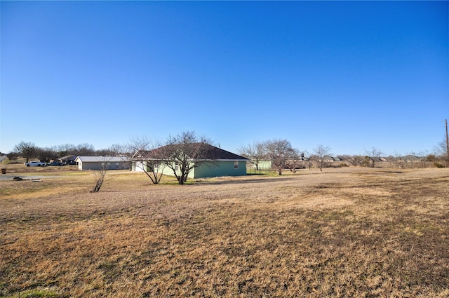 view of yard with a rural view