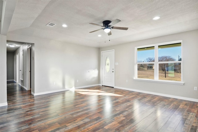 interior space with a textured ceiling, dark hardwood / wood-style floors, and ceiling fan