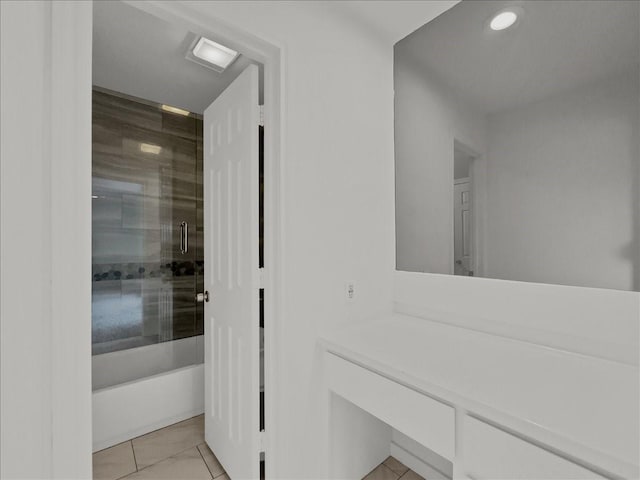 bathroom featuring tile patterned flooring and a tile shower