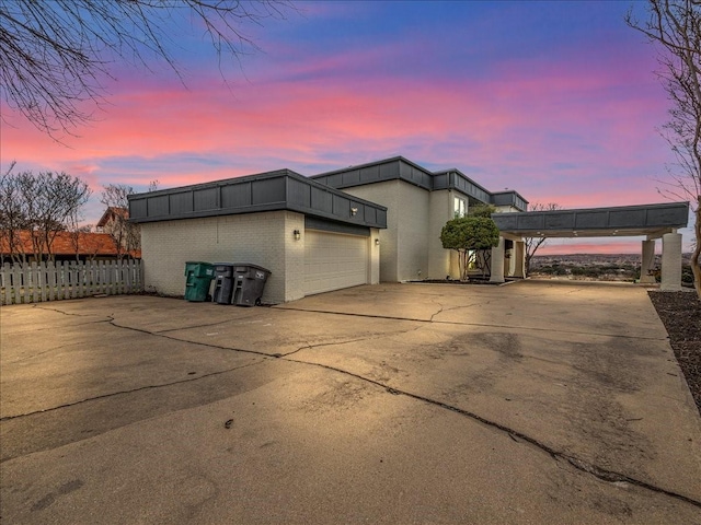 property exterior at dusk featuring a garage