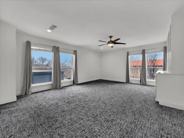 unfurnished living room with dark colored carpet and ceiling fan