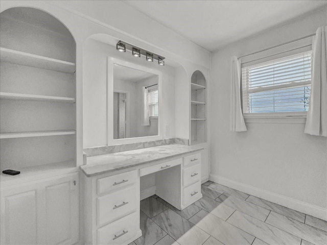 bathroom with a healthy amount of sunlight and vanity