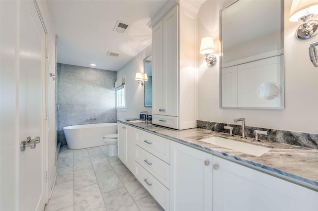 bathroom featuring vanity, a bathtub, and toilet