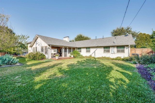 rear view of property with a yard