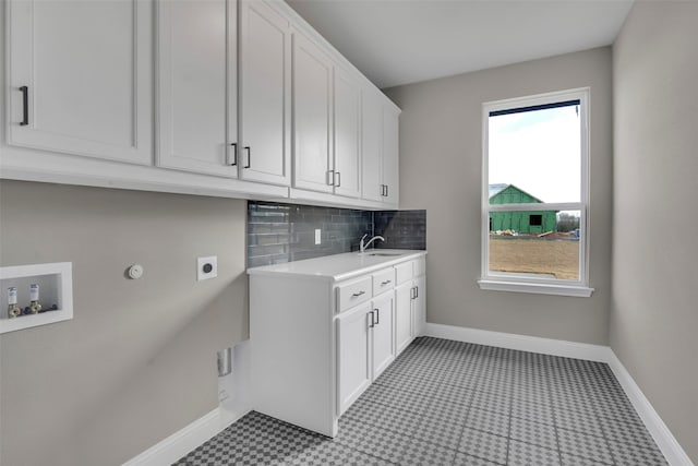 clothes washing area featuring sink, cabinets, hookup for a gas dryer, washer hookup, and electric dryer hookup