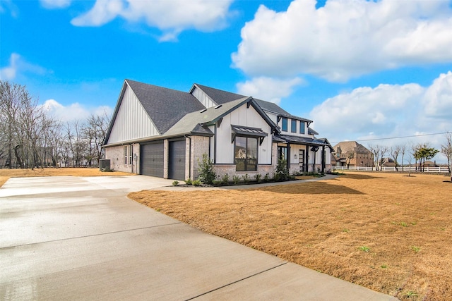 view of side of home with a yard and a garage