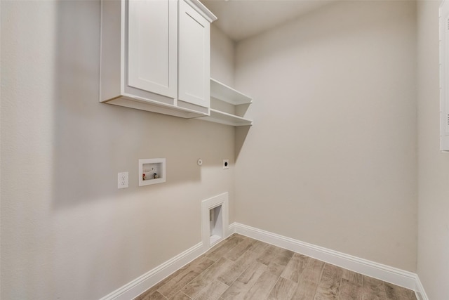 laundry room with gas dryer hookup, cabinets, light hardwood / wood-style flooring, hookup for a washing machine, and electric dryer hookup