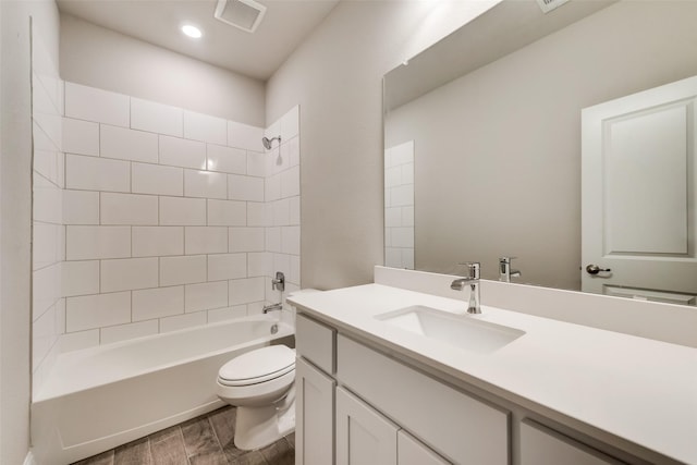 full bathroom with vanity, toilet, tiled shower / bath combo, and wood-type flooring