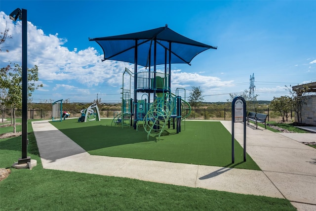 view of playground with a lawn