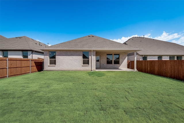 back of house featuring a yard and a patio area