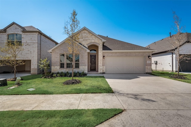 french country style house with a garage and a front lawn