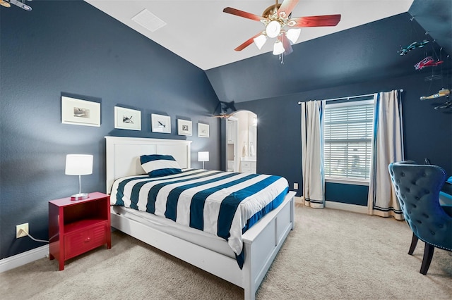 bedroom with baseboards, arched walkways, a ceiling fan, vaulted ceiling, and carpet floors