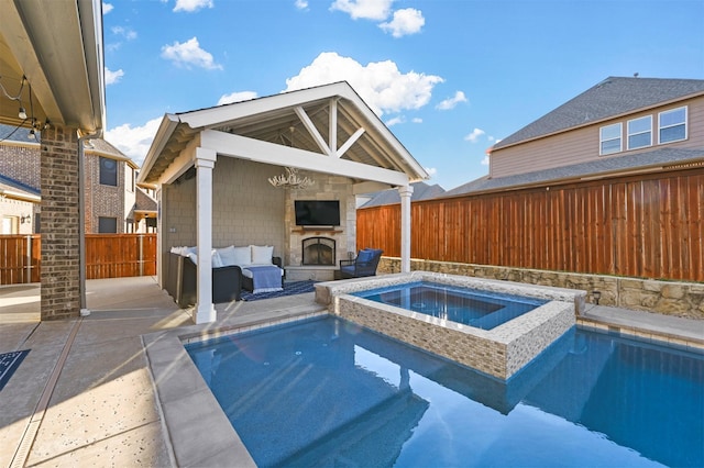 view of swimming pool with a fenced backyard, an in ground hot tub, a fenced in pool, an outdoor living space with a fireplace, and a patio area