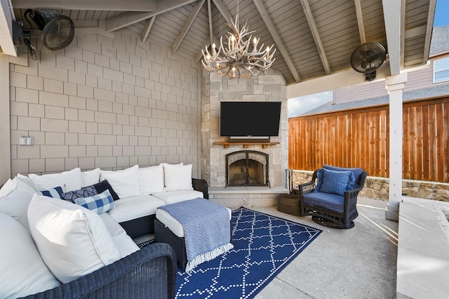 living area featuring an outdoor stone fireplace, high vaulted ceiling, an inviting chandelier, concrete flooring, and beamed ceiling