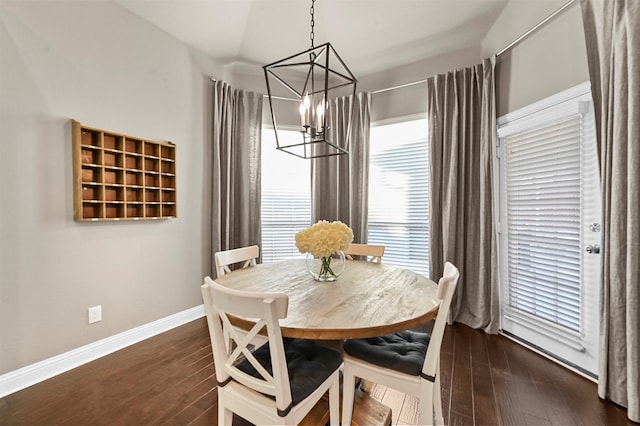 dining area with an inviting chandelier, baseboards, and dark wood finished floors