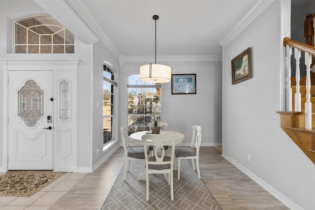 dining room featuring ornamental molding and light hardwood / wood-style floors