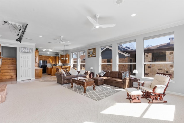 tiled living room with ornamental molding and ceiling fan