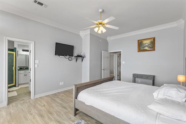 bedroom with crown molding, ceiling fan, light hardwood / wood-style floors, and ensuite bath