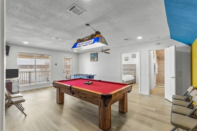 game room featuring billiards, a textured ceiling, and light hardwood / wood-style flooring