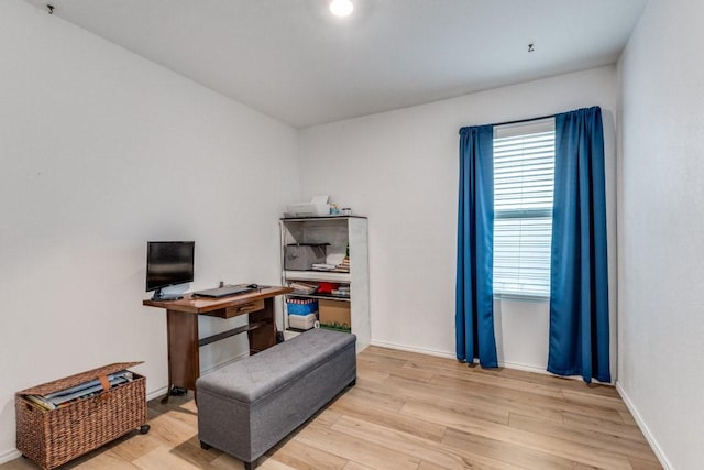 home office with light hardwood / wood-style flooring