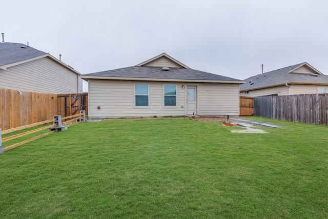 rear view of house with a lawn