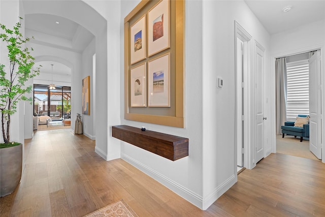 hallway with light hardwood / wood-style floors